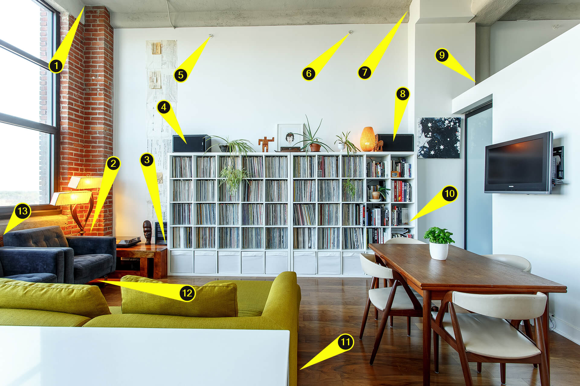 Speaker placement examples on casual game room image. A contemporary living room shown as a game room example with arrows pointing in various places that sound speakers could be positioned.