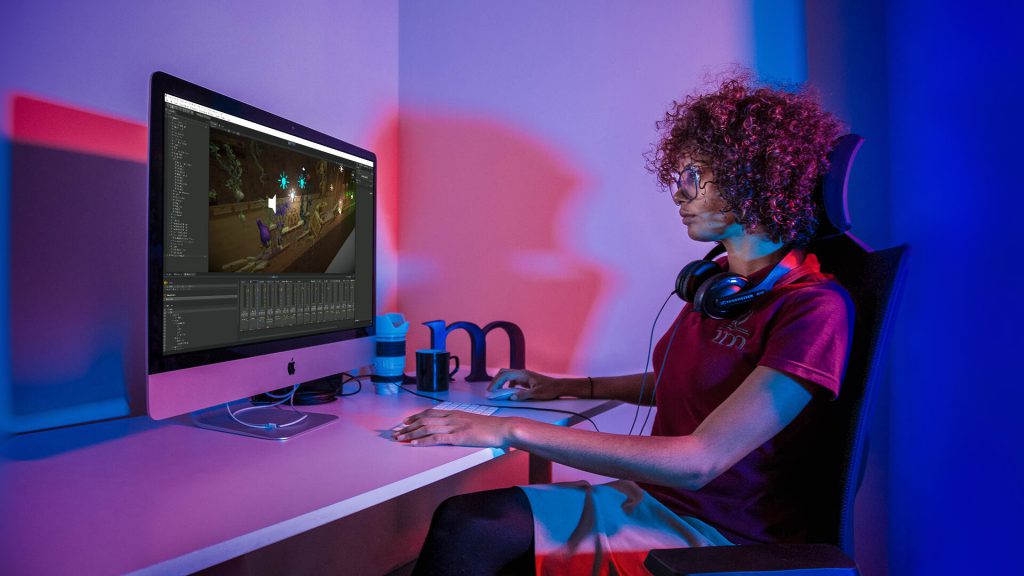 Image of Woman using silver iMac with Unity mixer.